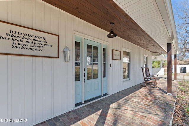 view of exterior entry featuring a patio