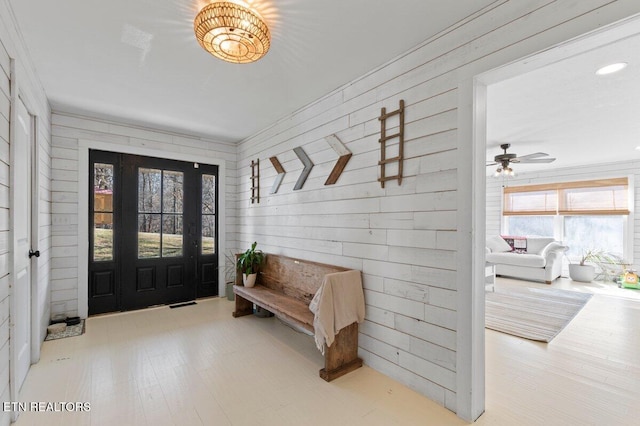 entrance foyer with hardwood / wood-style flooring and wood walls