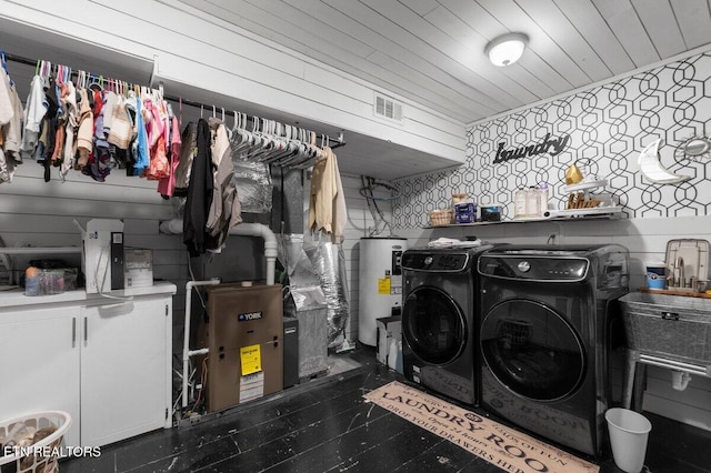 washroom with wood ceiling, cabinets, separate washer and dryer, and electric water heater