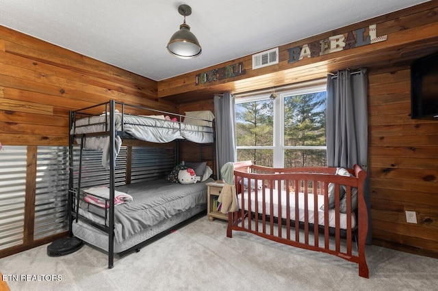 bedroom featuring carpet floors and wood walls