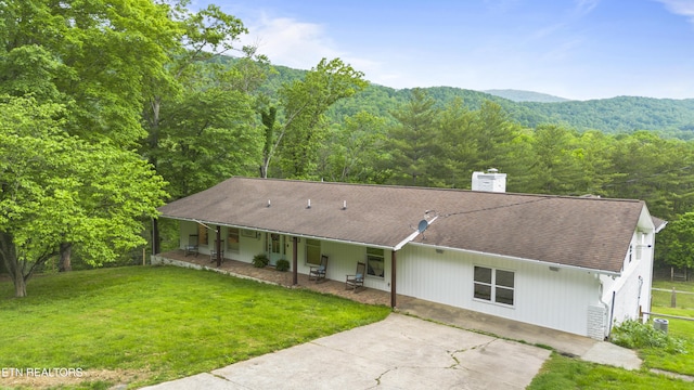 352 Bates Ln, Caryville, TN 37714 - back of property with covered porch, a yard, and a chimney