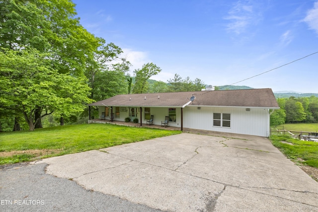 352 Bates Ln, Caryville, TN 37714 - view of front of home featuring concrete driveway, a front yard, and a chimney