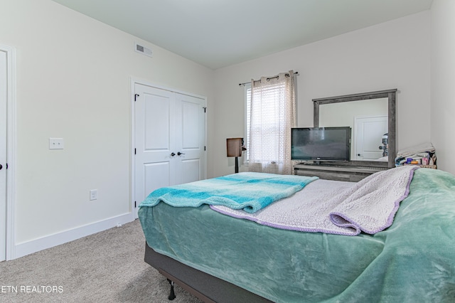 carpeted bedroom with a closet