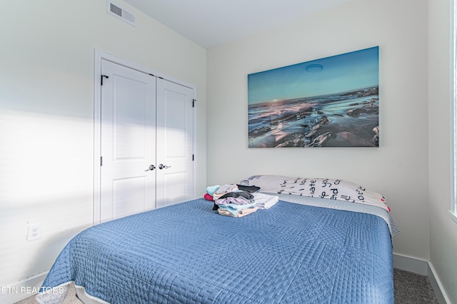 carpeted bedroom featuring a closet