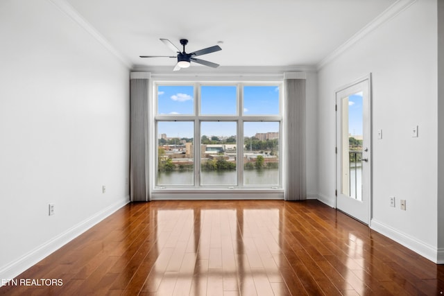 empty room featuring hardwood / wood-style floors, crown molding, ceiling fan, and a water view