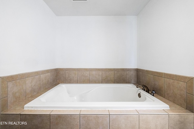 bathroom with tiled bath