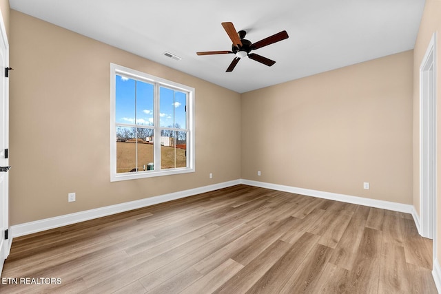 spare room featuring light hardwood / wood-style flooring and ceiling fan