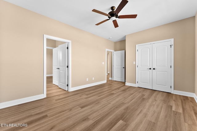 unfurnished bedroom with ceiling fan, a closet, and light hardwood / wood-style flooring