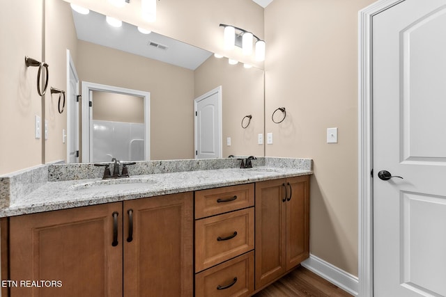 bathroom with hardwood / wood-style flooring and vanity