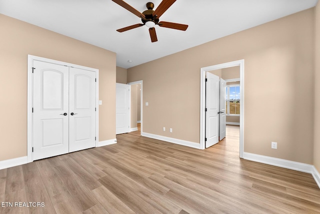 unfurnished bedroom featuring a closet, ceiling fan, and light wood-type flooring