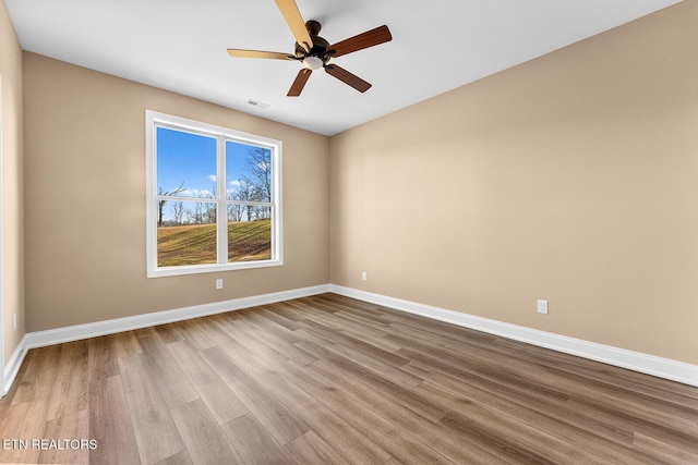 unfurnished room featuring ceiling fan and hardwood / wood-style floors