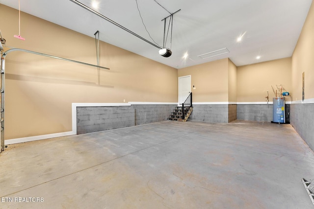 garage featuring a garage door opener and electric water heater