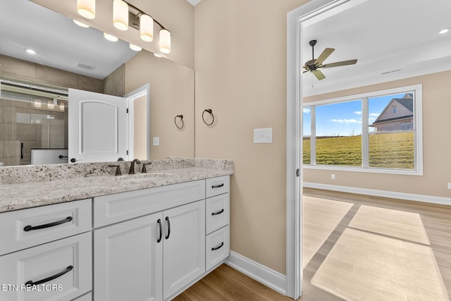 bathroom with ceiling fan, vanity, a shower with door, and hardwood / wood-style floors