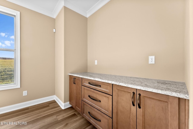 interior details with wood-type flooring and ornamental molding