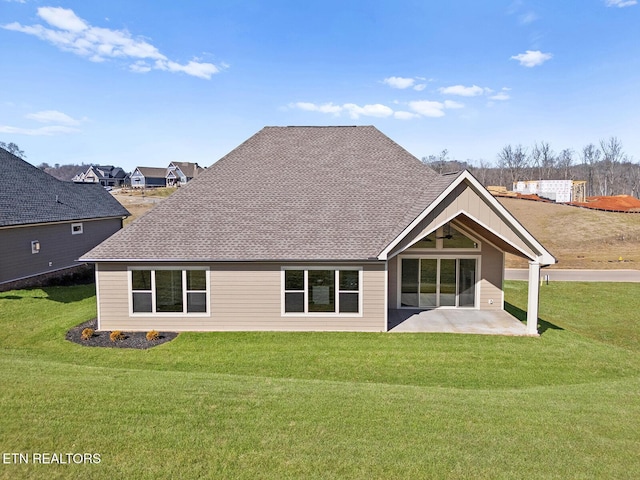 rear view of property with a patio area and a lawn