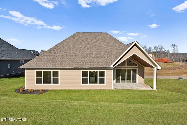 rear view of house with a patio area and a lawn