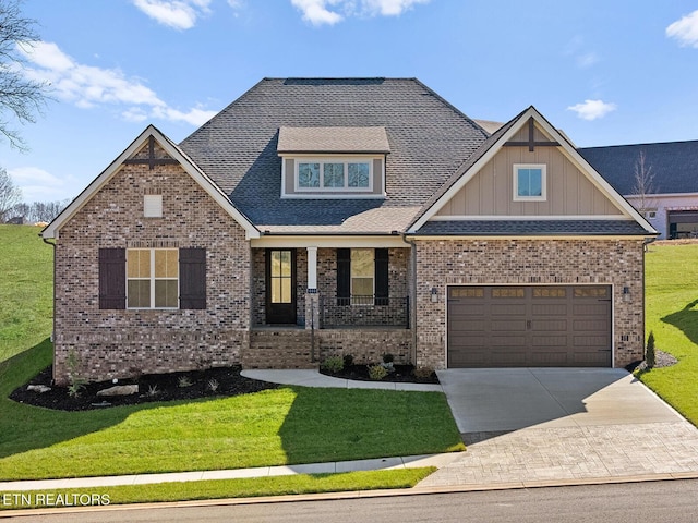 craftsman house featuring a garage, a front yard, and covered porch