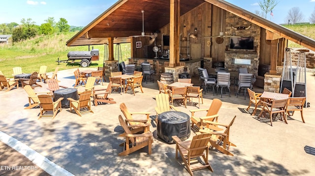 view of patio / terrace featuring a fireplace and an outdoor bar