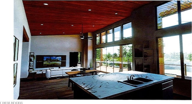 kitchen featuring a towering ceiling, wood ceiling, open floor plan, a sink, and recessed lighting