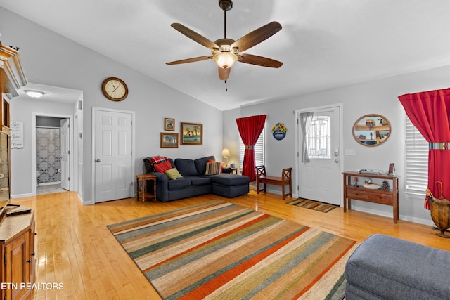 living room with ceiling fan, lofted ceiling, and light hardwood / wood-style floors