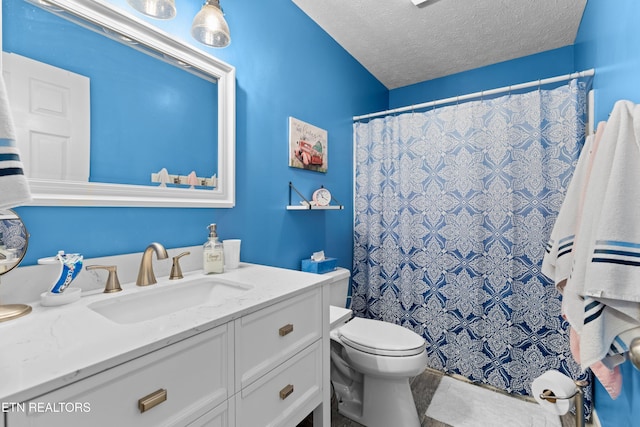 bathroom featuring a shower with curtain, vanity, a textured ceiling, and toilet