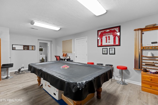 rec room featuring hardwood / wood-style flooring, billiards, and a textured ceiling