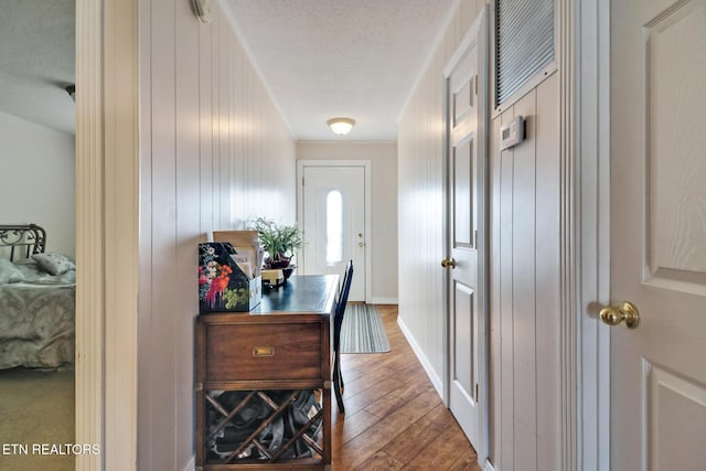 doorway with hardwood / wood-style floors and a textured ceiling