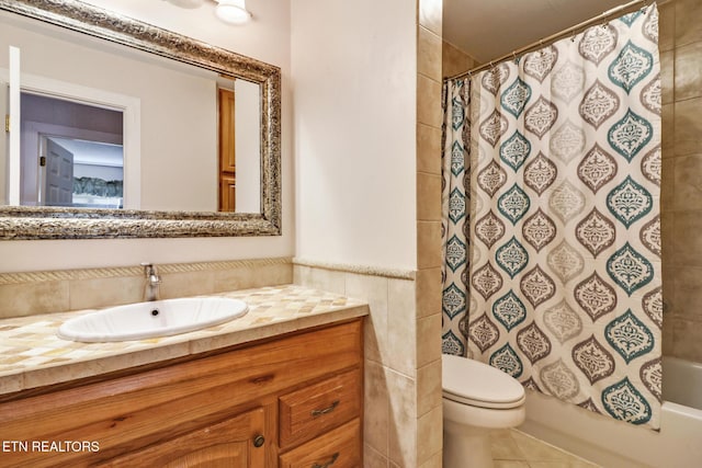 full bathroom featuring toilet, tile walls, vanity, shower / bath combo, and tile patterned flooring