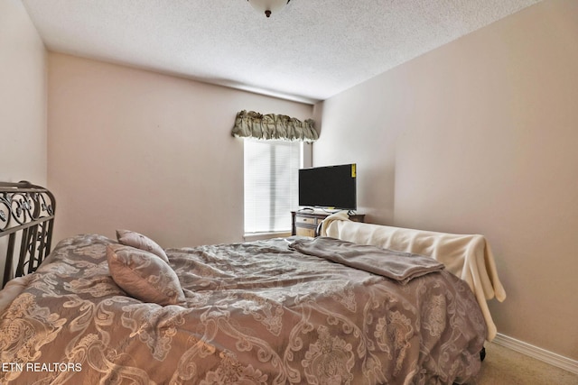 carpeted bedroom with a textured ceiling