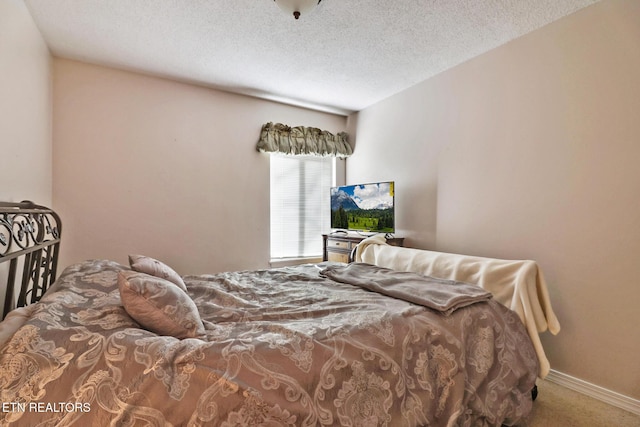 bedroom with carpet flooring and a textured ceiling