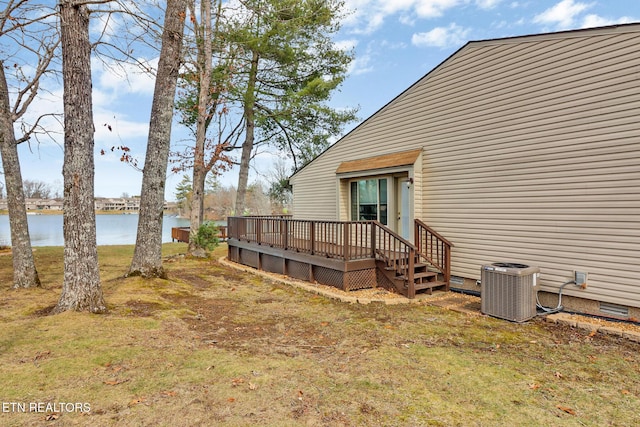 view of yard featuring cooling unit and a deck with water view