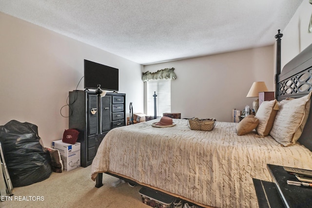 bedroom featuring carpet floors and a textured ceiling