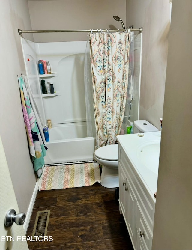 full bath with toilet, wood finished floors, visible vents, vanity, and shower / bath combo with shower curtain