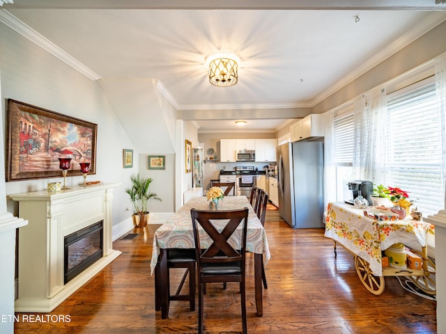 dining area featuring crown molding and dark hardwood / wood-style floors