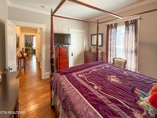 bedroom featuring crown molding and wood-type flooring