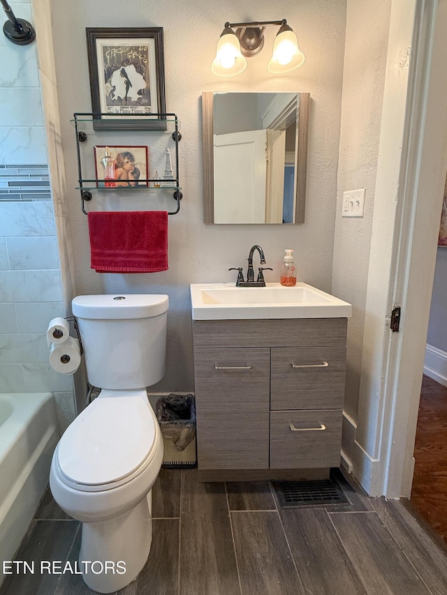 full bathroom with vanity, shower / bathtub combination, and toilet