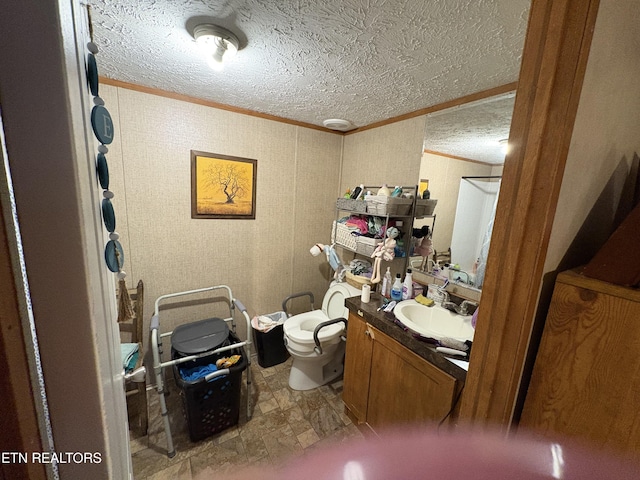 bathroom with crown molding, vanity, a textured ceiling, and toilet