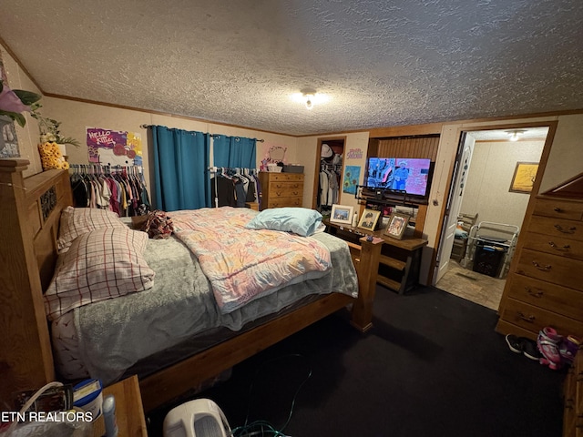 bedroom with crown molding, dark carpet, and a textured ceiling