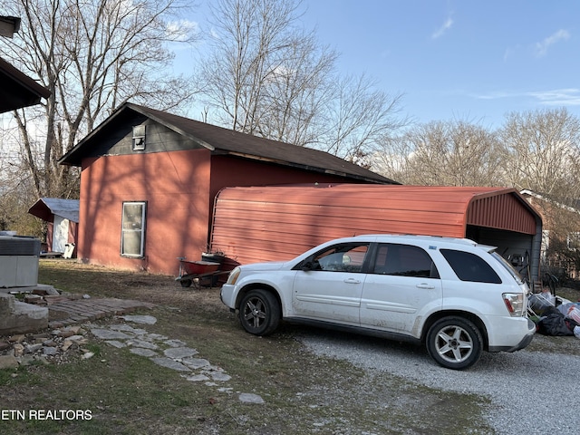 view of side of home with central air condition unit