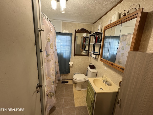 bathroom with vanity, ornamental molding, a textured ceiling, tile patterned floors, and toilet