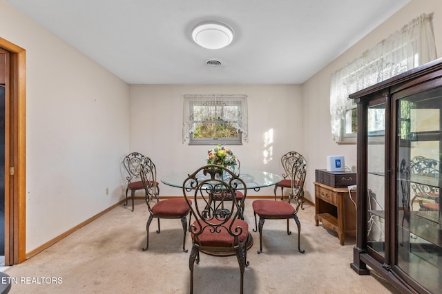 dining area with light colored carpet