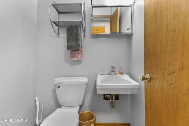 bathroom featuring sink and toilet