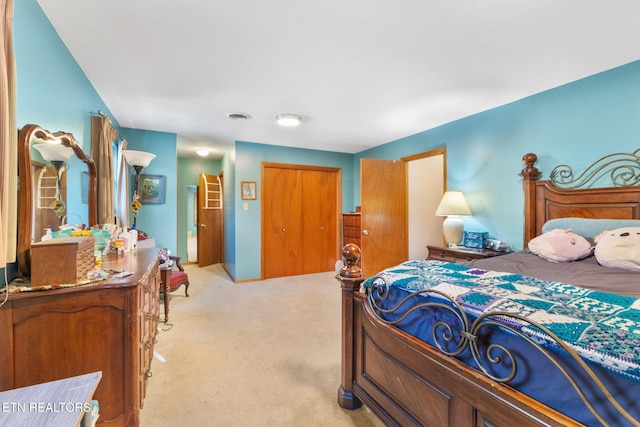 bedroom featuring light carpet and a closet