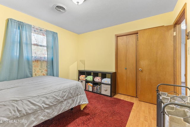 bedroom featuring light hardwood / wood-style floors and a closet