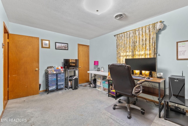 office with light carpet and a textured ceiling