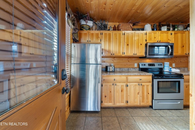 kitchen featuring wood ceiling, tile patterned floors, and appliances with stainless steel finishes