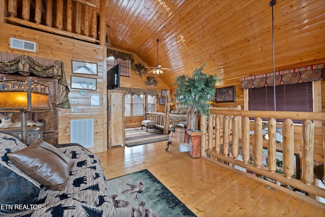 living room featuring wood ceiling, hardwood / wood-style flooring, ceiling fan, wooden walls, and high vaulted ceiling