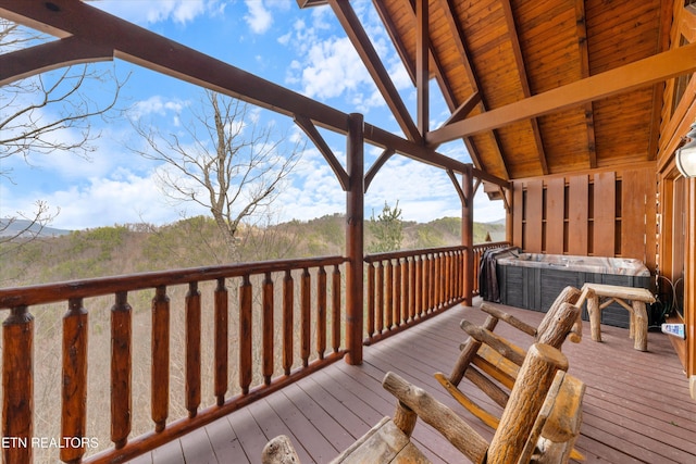 wooden deck with a hot tub