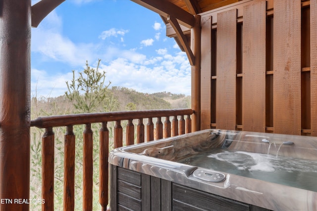 deck featuring a hot tub