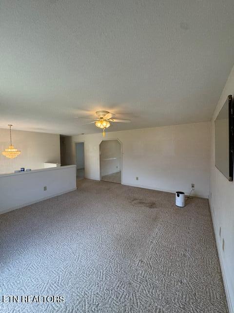 spare room featuring ceiling fan, carpet floors, and a textured ceiling